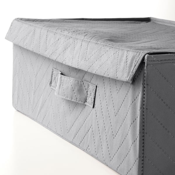 Close-up of texture on gray fabric storage bin with lid and handle.