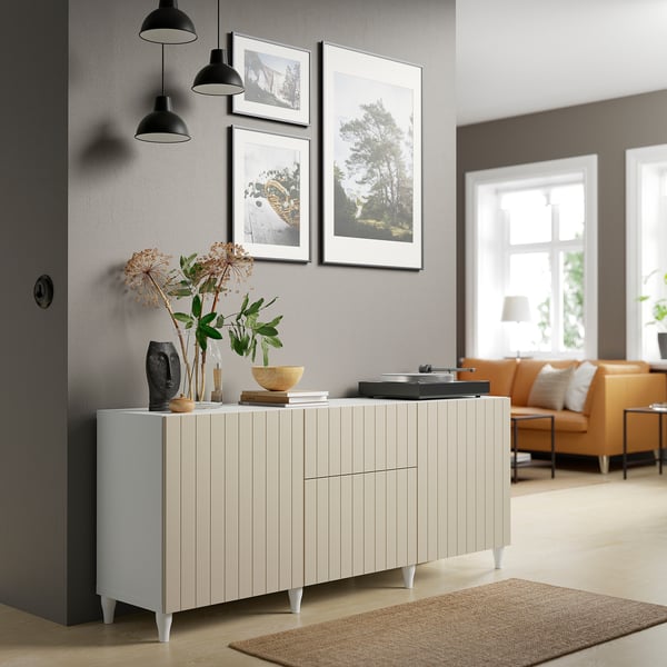 Modern living room with BESTÅ sideboard, orange sofa, and wall art