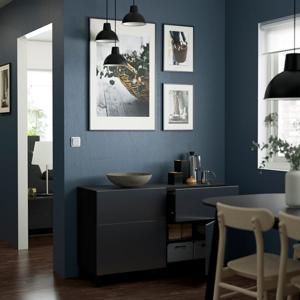 Modern dining room with grey sideboard, photos, and pendant lamps.
