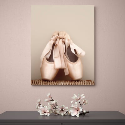 Ballet slippers on canvas over piano keys, with flowers below.