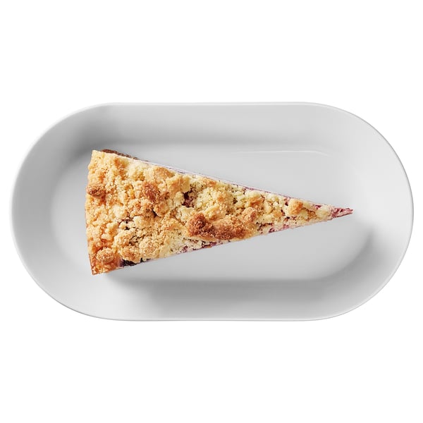 A piece of cake on a white plate, featuring a golden-brown crust and crumbly texture.