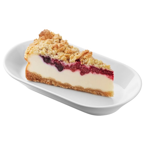 A slice of berry crumble cheesecake on a white plate. Creamy filling, crunchy topping.