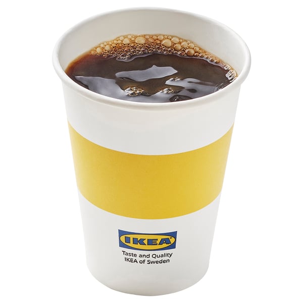 Disposable ikea coffee cup with yellow and white design.