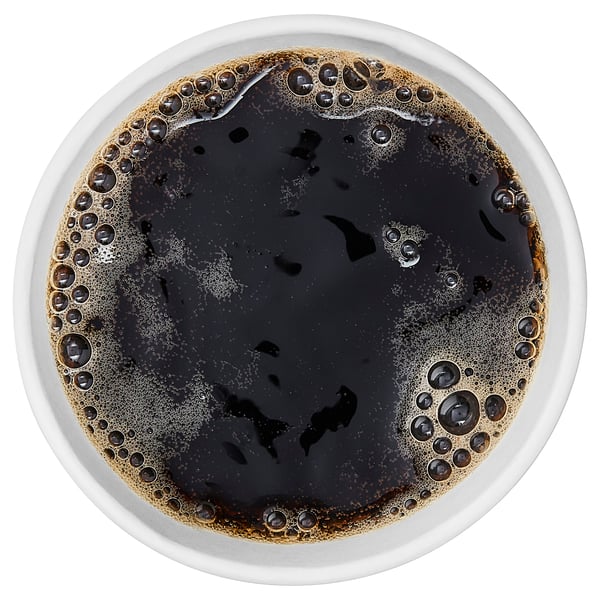 Top view of a cup filled with dark, bubbly liquid, likely flavored coffee or drink.