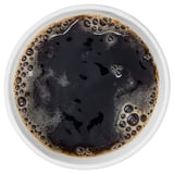 Top view of a cup filled with dark, bubbly liquid, likely flavored coffee or drink.