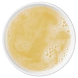 Image shows a bowl of golden-yellow liquid, likely a sauce or soup, bubbling and ready to serve.