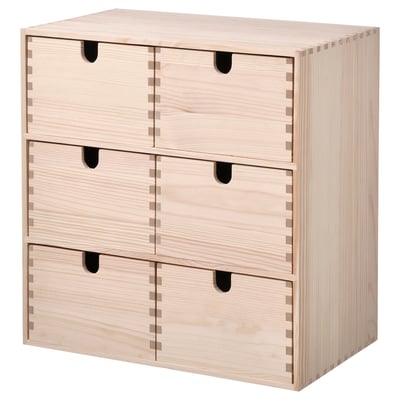 An ikea MOPPE mini chest with multiple drawers. Its light-colored, made of pine, and a classic, simple design.
