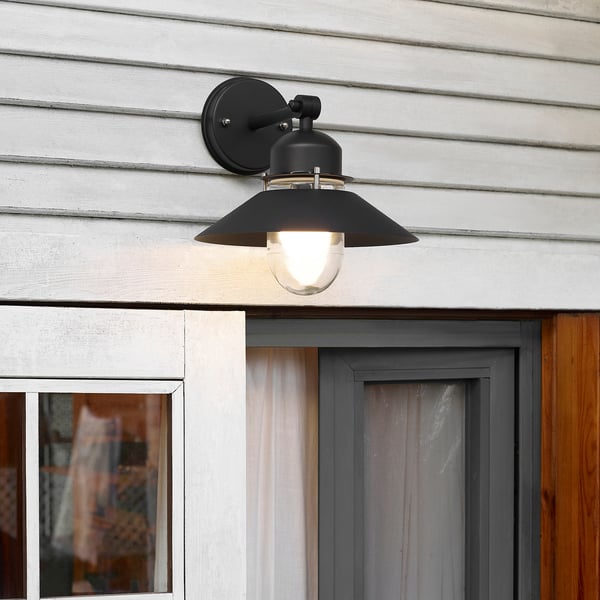 Black wall lamp UPPLID near door, modern glass design, fits outdoor spaces.