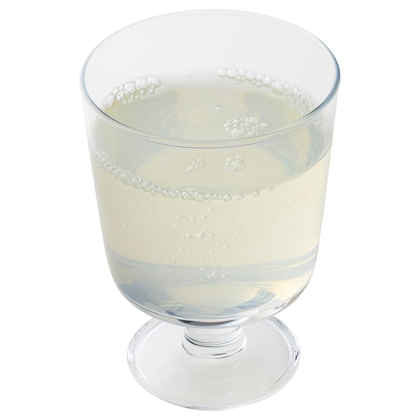 Glass filled with clear, bubbly liquid, likely a sparkling beverage.
