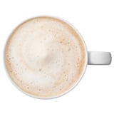 Top view of a cup of frothy coffee in a white mug.