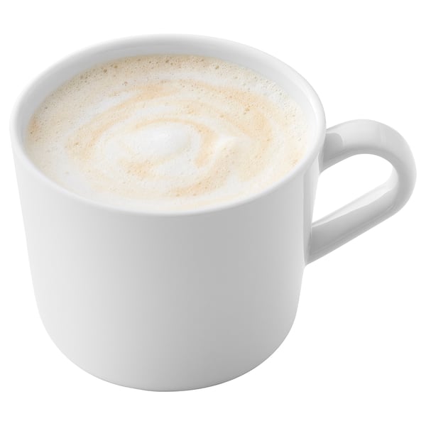 A white mug filled with a creamy foam-topped coffee drink.