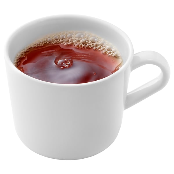 A white ceramic mug filled with steaming tea. Simple design, standard handle on right.