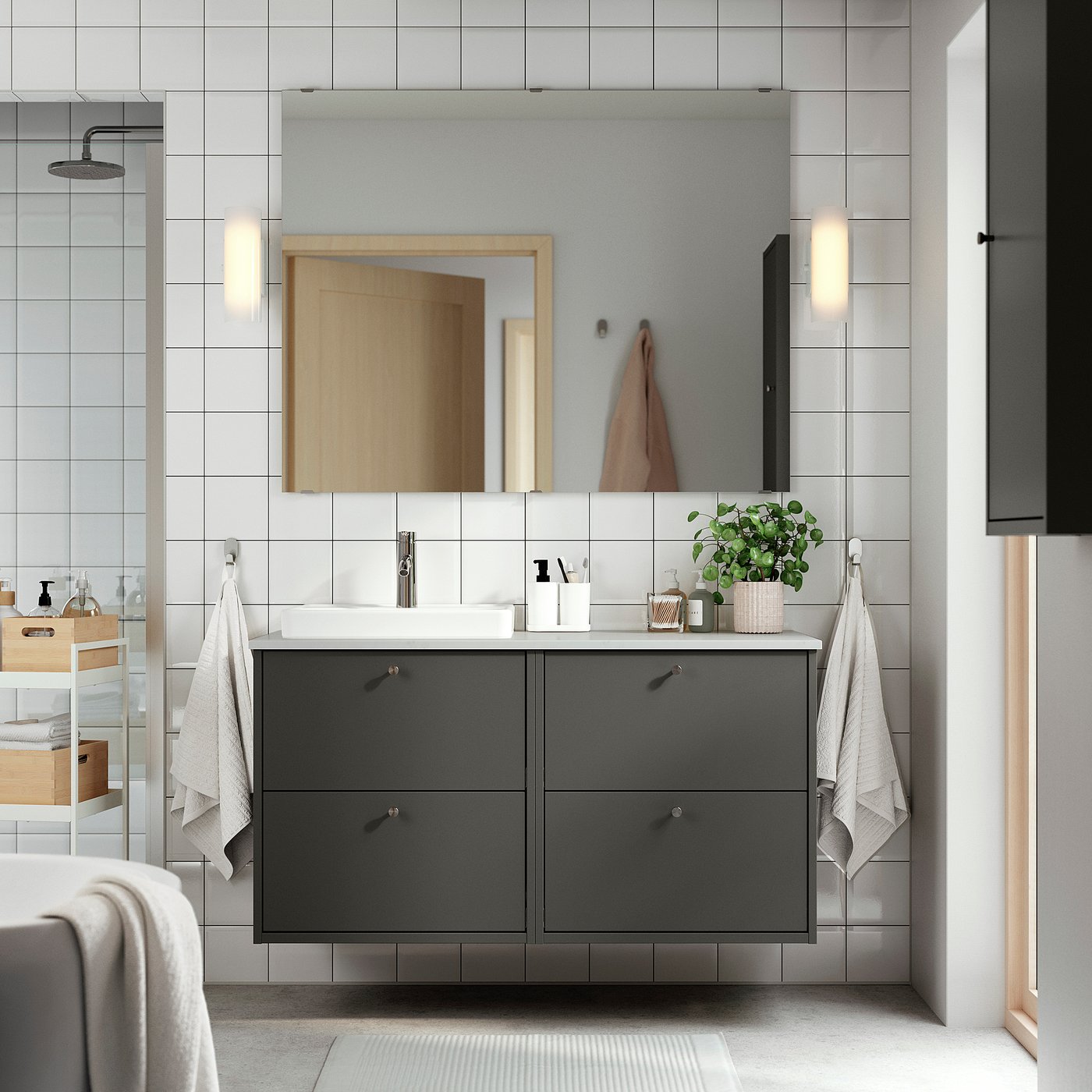 Grey HAVBÄCK vanity with white countertop and mirror in modern bathroom.