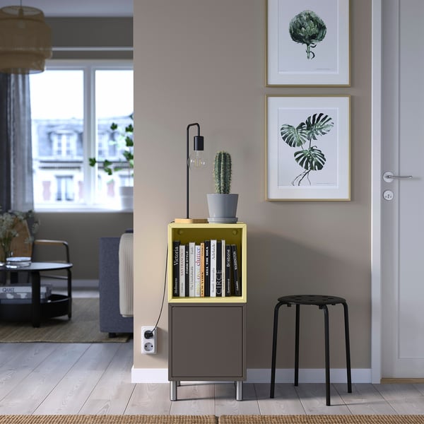 EKET storage: gray/yellow, books, cactus, lamp, stool, door, prints.