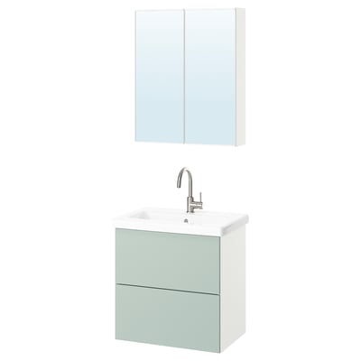 Green cabinet, white sink, mirror above.
