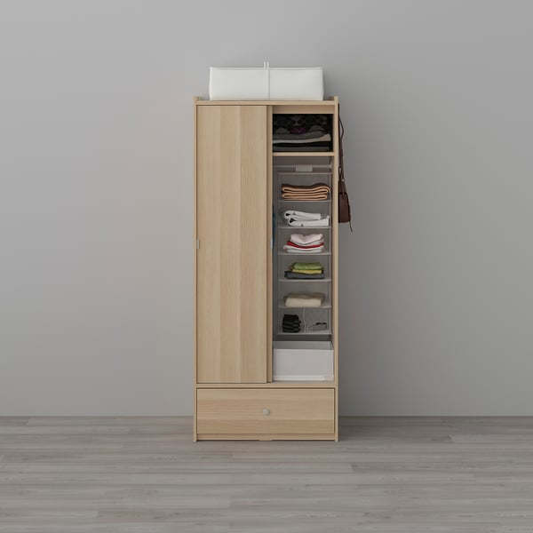 Oak wardrobe with sliding doors and storage solutions for clothes.