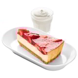 A slice of strawberry cheesecake on a plate with a cup of whipped cream.