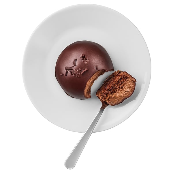 Plate with a chocolate dessert, half-eaten, silver spoon. Rich, dense texture, smooth surface.