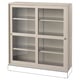 A HAVSTA light beige wooden cabinet with glass doors and shelves. It has a rectangular shape and a sleek design, ideal for displaying items dust-free.