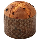 A round, golden-brown baked good with dark spots, wrapped in patterned paper. It appears to be a type of pastry or bread.