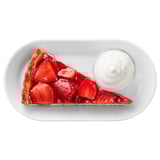 A slice of strawberry cake with cream on a white plate.