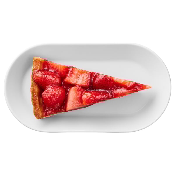 A slice of strawberry cream cake on a plate, featuring fresh strawberries and a soft crust.