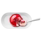 Image shows a dessert: red glaze, raspberry filling, on white plate. Spoon included.