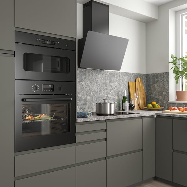 Modern kitchen with black BRÄNDBO oven, microwave, and grey cabinets; sleek appliances dominate counter space.