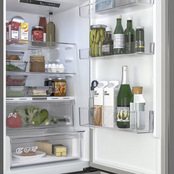 Fridge with humidity crisper, no-frost system, and adjustable shelves, demonstrating organized storage of various foods and drinks.