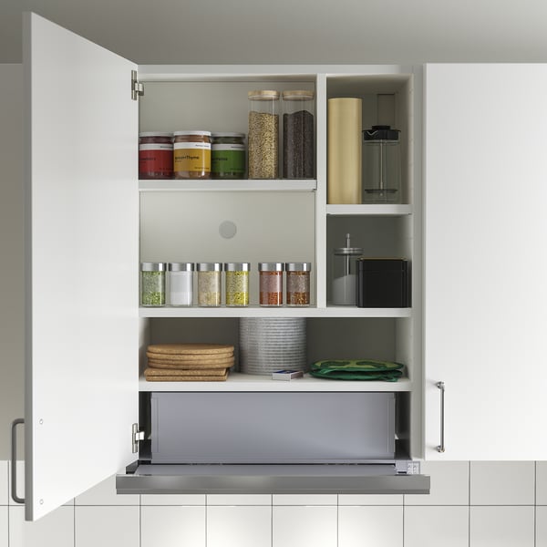 Open kitchen cabinet with UTDRAG built-in extractor; reveals pull-out lower part, led light, and shelves with jars and kitchen items.