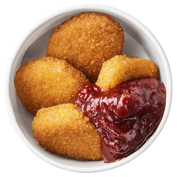 Bowl of crispy, breaded plant-based bites with lingonberry sauce. Great for vegetarians and flexitarians.