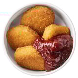 Bowl of crispy, breaded plant-based bites with lingonberry sauce. Great for vegetarians and flexitarians.