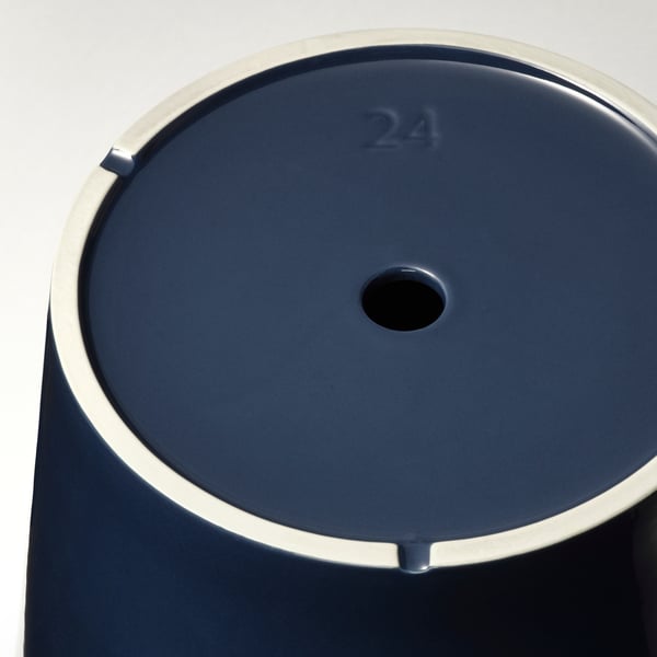 Dark blue modern planter with metal rim, numbered 24, sits on a plain surface, showcasing its sleek design.