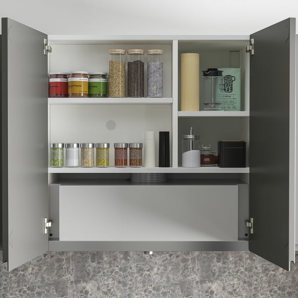 Kitchen cabinet with spice jars and containers, including hidden extractor hood.