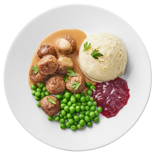 Talerz klopsików, groszku, puree ziemniaczanego i dżemu.