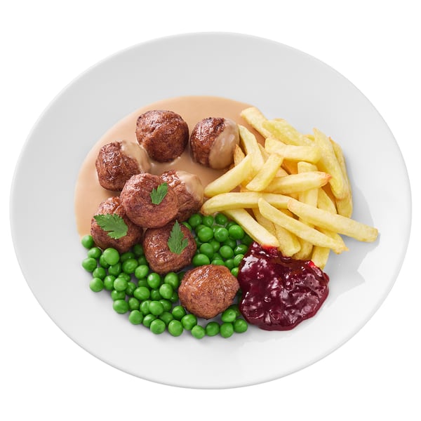 Platte mit Fleischbällchen, Erbsen, Pommes frites und Sauce.