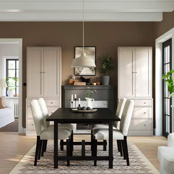 Small, light-colored HAVSTA chest of drawers fits neatly between two tall units in modern dining room.