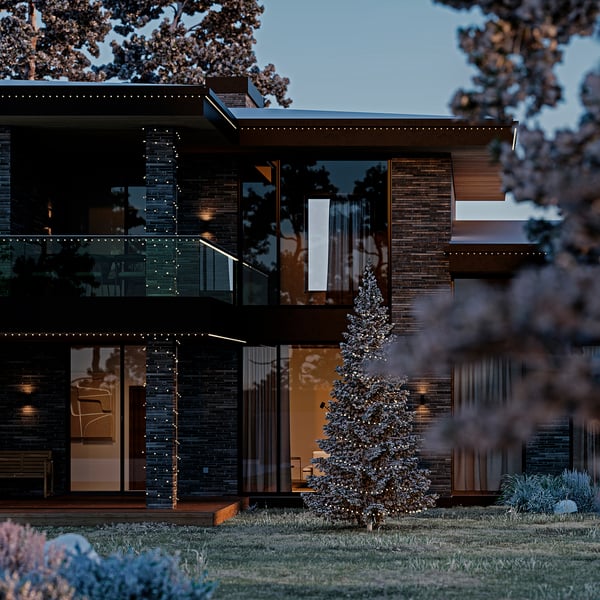 Modern house with decorated tree lit by warm white GETKÅL lights, blending with outdoor decor.