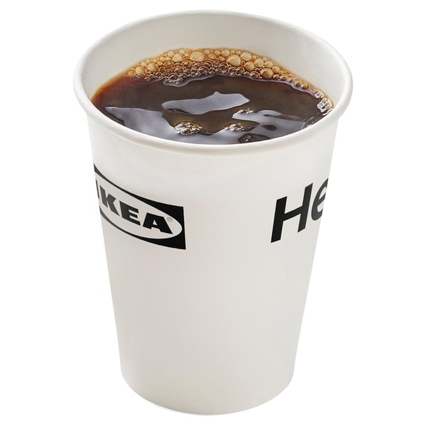 Disposable paper cup with dark liquid, IKEA logo, white.
