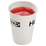 Image shows a white IKEA cup filled with red liquid, likely a food item.