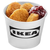 IKEA container filled with crispy, breaded plant-based pieces and dark sauce, likely lingonberry and bbq.