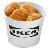 A white container with the IKEA logo filled with crispy, golden-brown, plant-based food items.