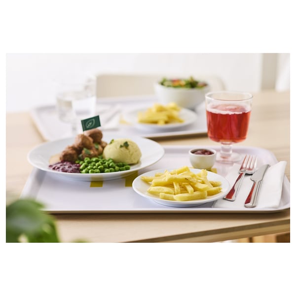 A meal on a white tray with plates of food and cutlery.