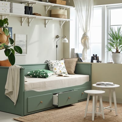 Łóżko dzienne HEMNES w kolorze szaro-zielonym, niewielka sofa przekształcająca się w podwójne łóżko, z dużymi szufladami do przechowywania i lakierowanym wykończeniem.