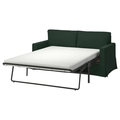 Ciemnozielona rozkładana sofa z białym materacem, metalowa rama, nowoczesny design.