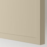 Gładki, beżowy front szafki z subtelną ramką. Pokazuje matowe wykończenie i czyste linie, wskazując na jakość i nowoczesny design.