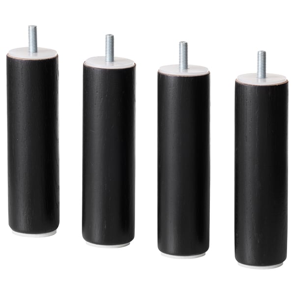 Cztery czarne cylindryczne drewniane nogi z metalowymi na górze, przeznaczone do mebli.