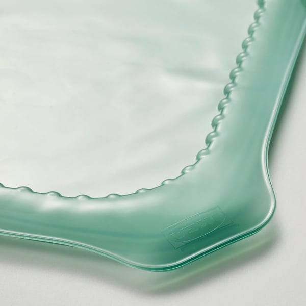 Turkusowa osłona na żywność z gumy silikonowej.