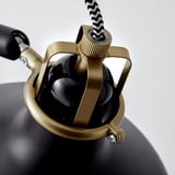 Zbliżenie lampy RANAP, złoto i czerń, regulowany przegub, detale tekstury.