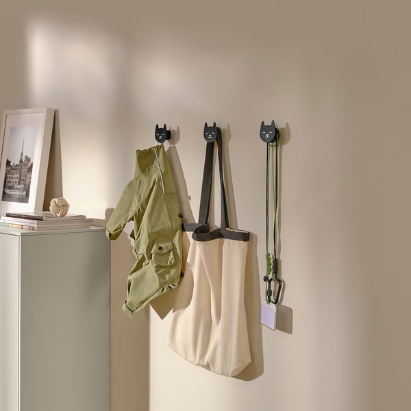 Ozdobne haczyki ścienne w kształcie kota na płaszcz, torbę i klucze; część serii UTSÅDD, zaprojektowanej do kreatywnego organizowania i przechowywania przedmiotów codziennego użytku.